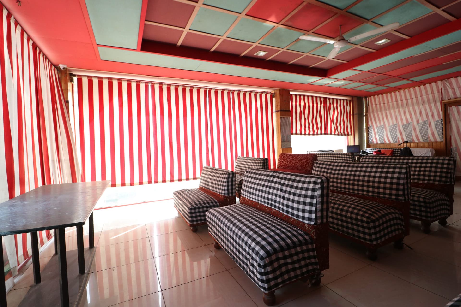 Upstairs seating lounge with cushioned chairs at Hotel Amar & Restaurant