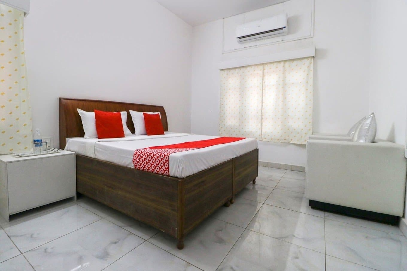 Air-conditioned guest room with double bed and marble flooring
